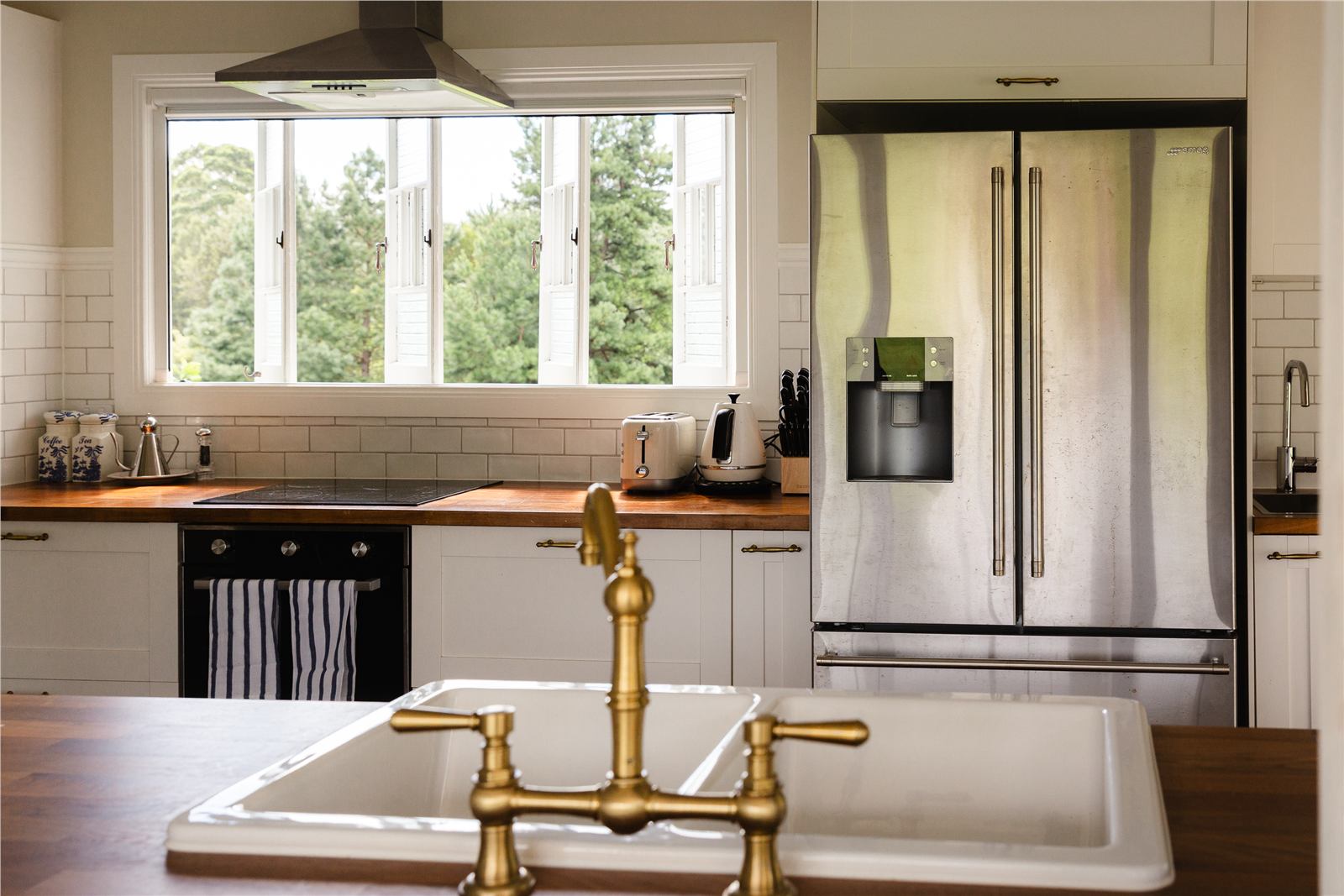 Kitchen with timber benchtop and brass tap