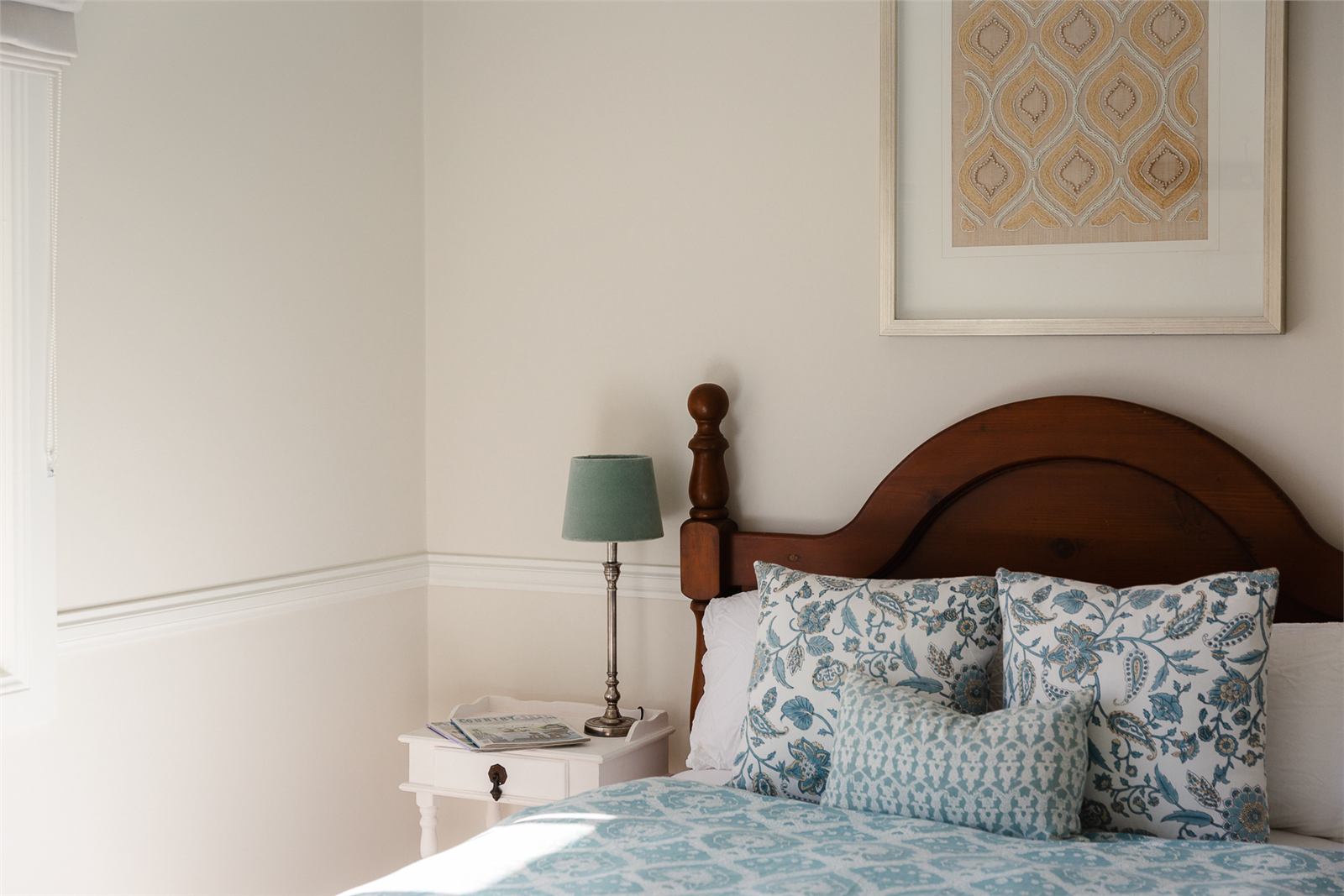 Second bedroom with queen bed, blue bedding and lamp